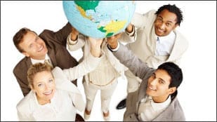multicultural group of people holding up a large globe