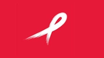 white brush stroke ribbon on red background for World AIDS Day
