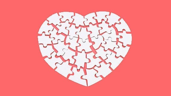 white heart puzzle on coral pink background