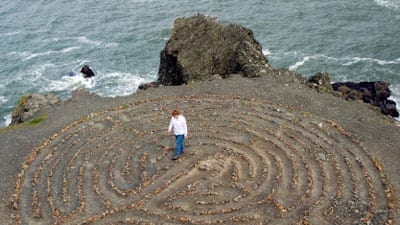 woman walking along a stone meditation labyrinth