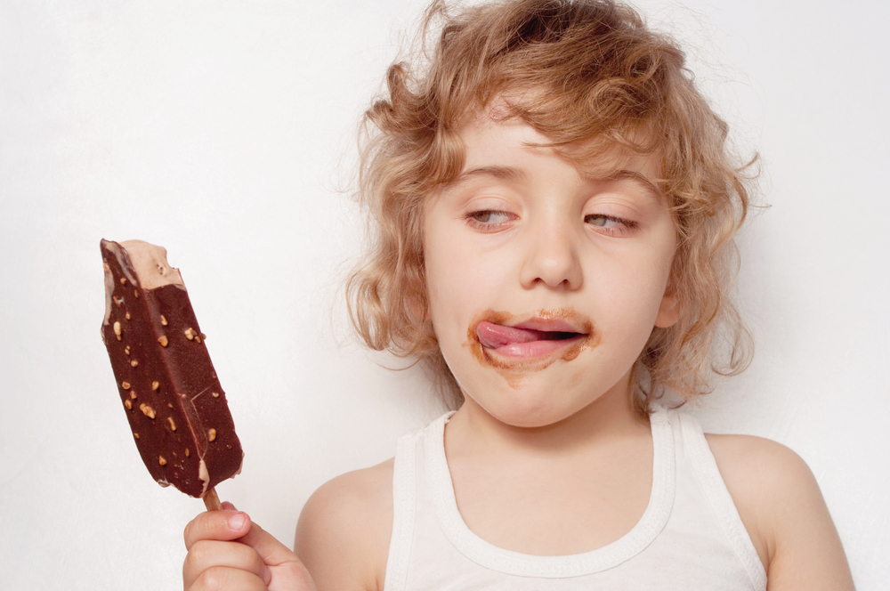 A child enjoys chocolate ice cream procured in an inconsiderate manner.