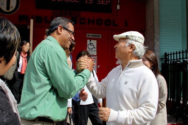 Ilchi Lee (right) meets with PS 001 principal Jorge Perdomo (left).