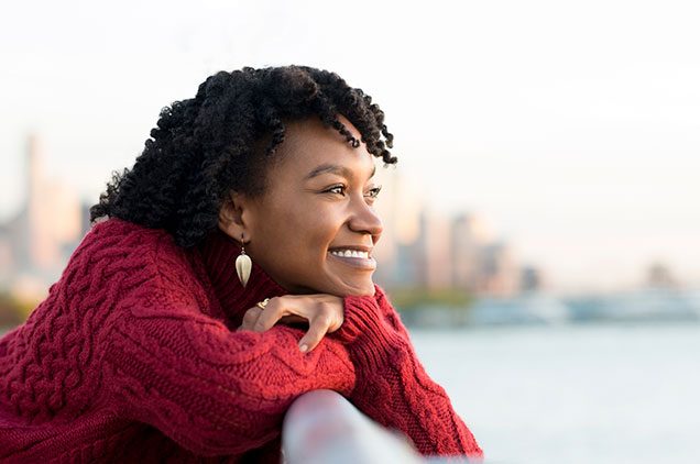 woman smiling while looking into the distance