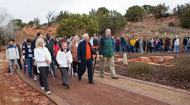 Ilchi Lee walking with students a the Healing Garden at Sedona Mago Retreat