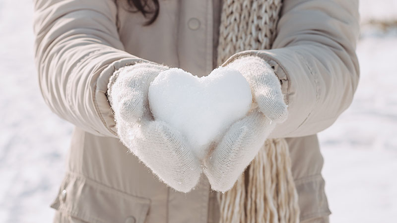 Woman holding a snow heart