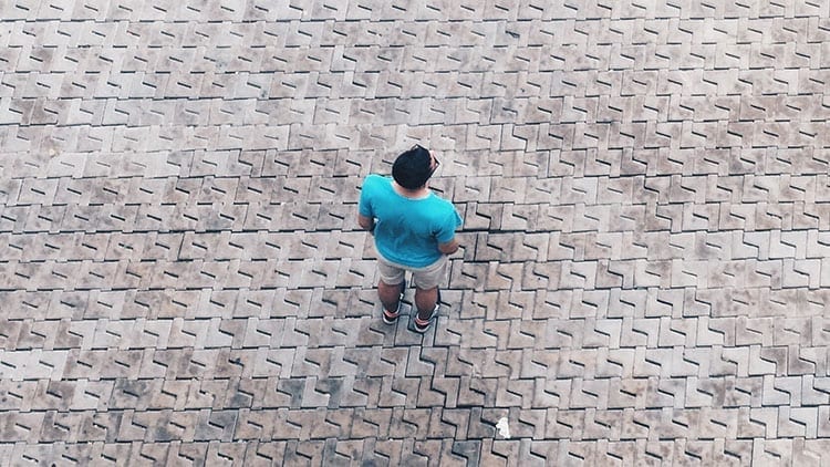birds eye view of man standing on stone pavement