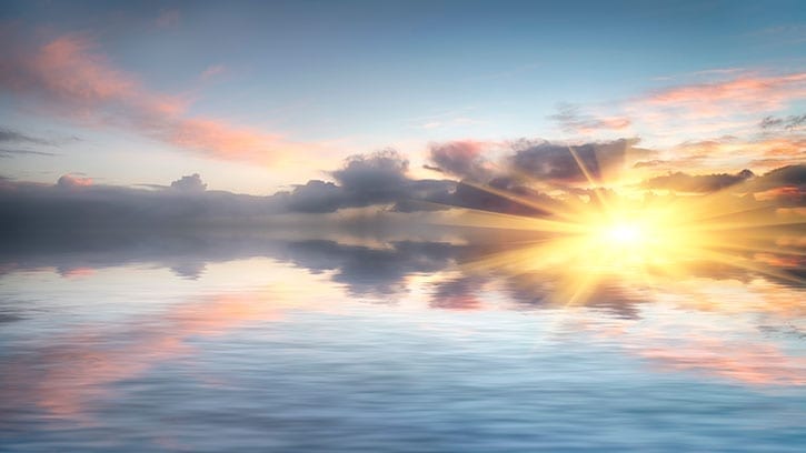 sunrise sky reflecting over still water