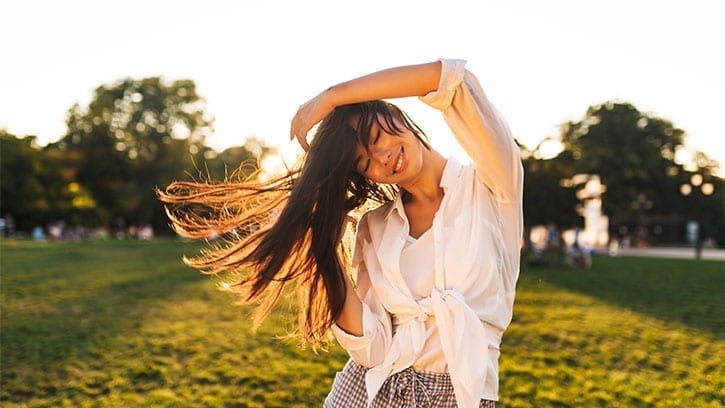 Asian woman dancing in the sun