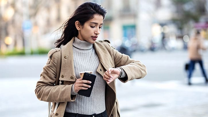 young woman looking at a watch