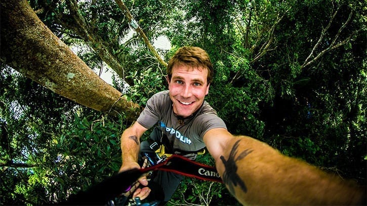 man climbing the high trees