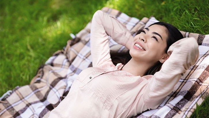 Asian woman lying in the grass