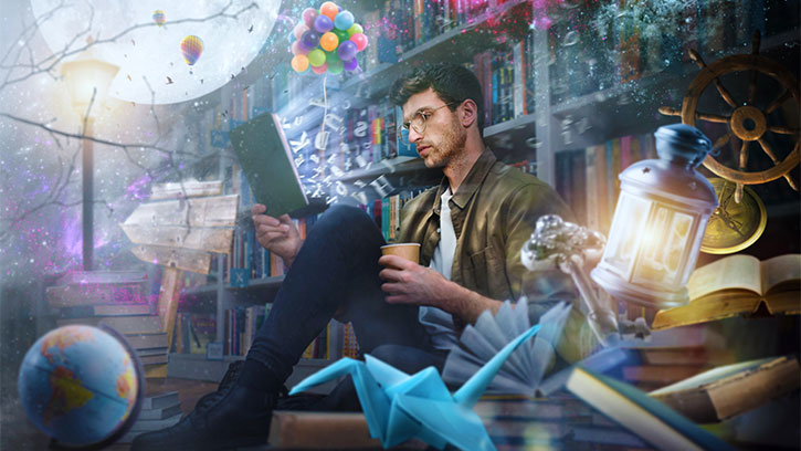 man reading while surrounded by dream objects