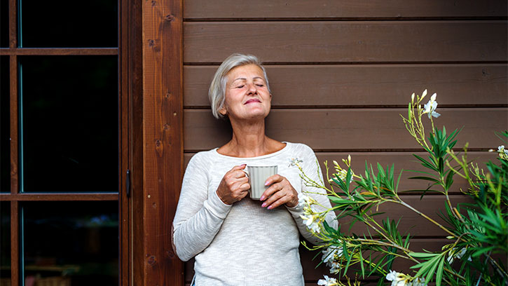 woman enjoying hot beverage outside