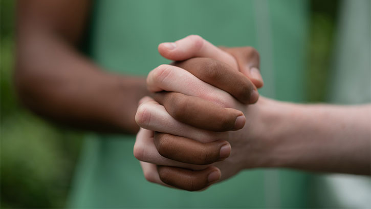 dark and light skin holding hands