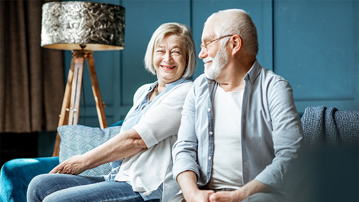 senior couple sitting on a couch