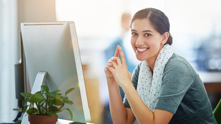 Loving every minute of my work. Portrait of a young designer working at her computer in an office