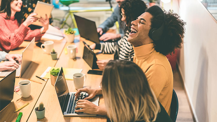 Young multiracial people having fun working inside coworking office