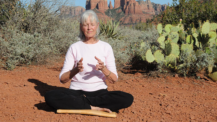 Woman in Sedona, Arizona doing energy meditation with hands