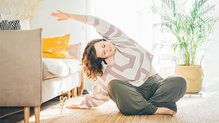 woman stretching in a living room