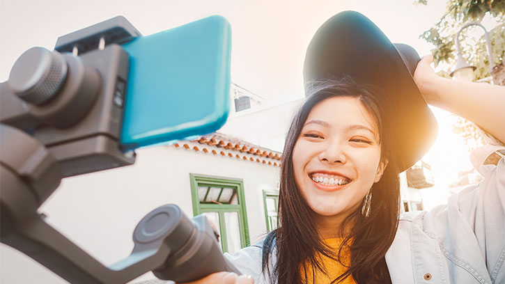 young Asian woman taking a selfie, smiling