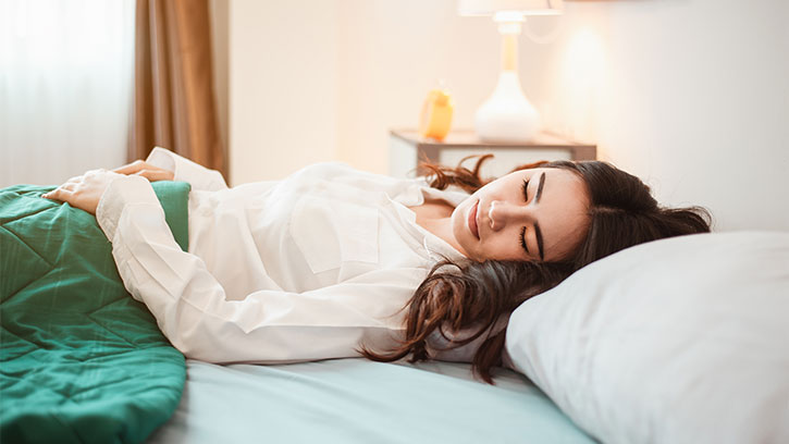 young woman sleeping on a bed