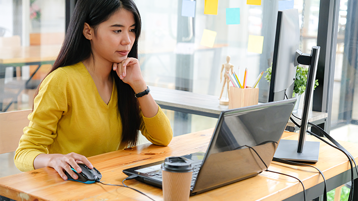 woman focusing on her work at a desk in an office